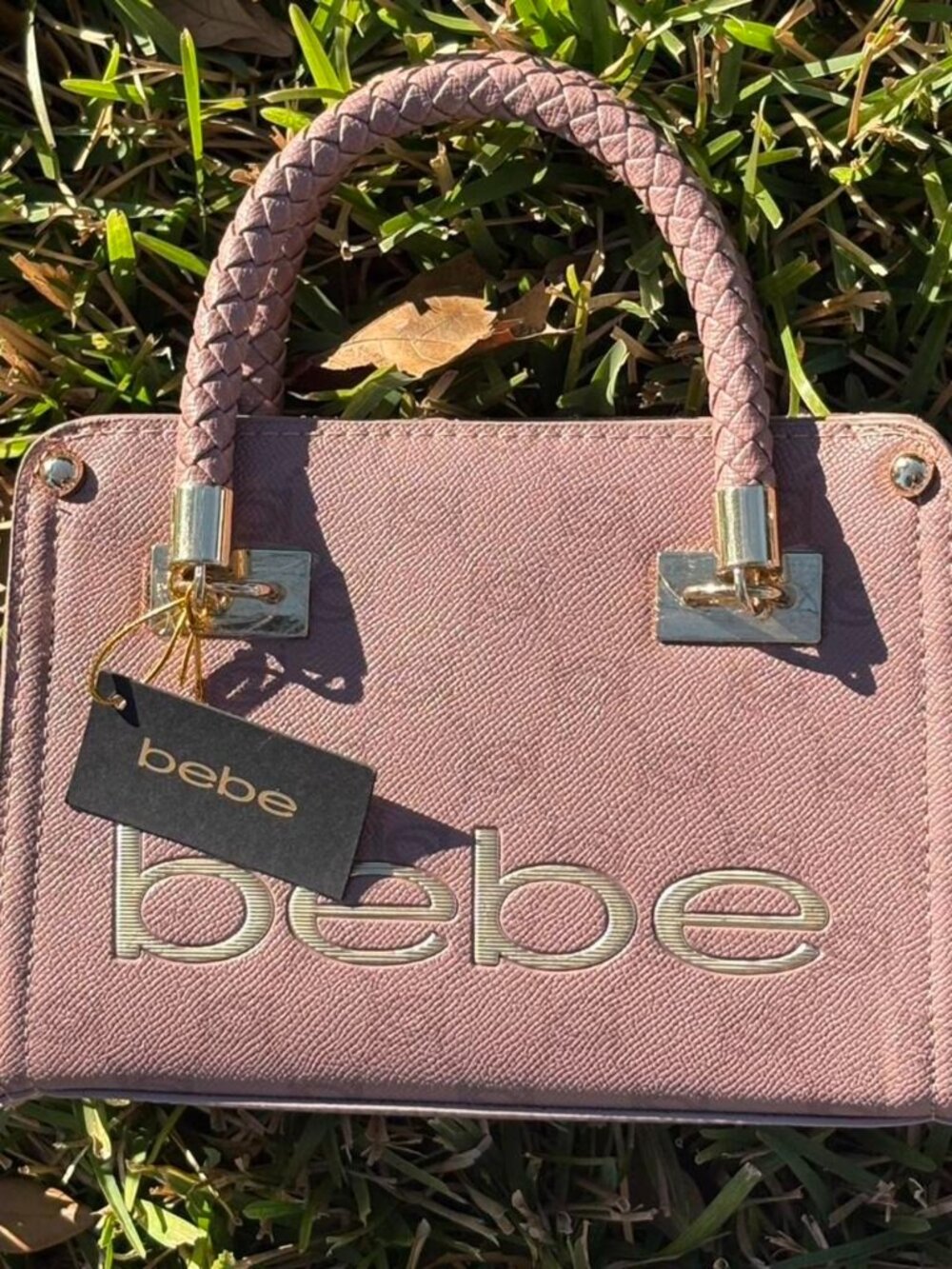 Pink Bebe bag with silver hardware, featuring a zipper closure and multiple pock